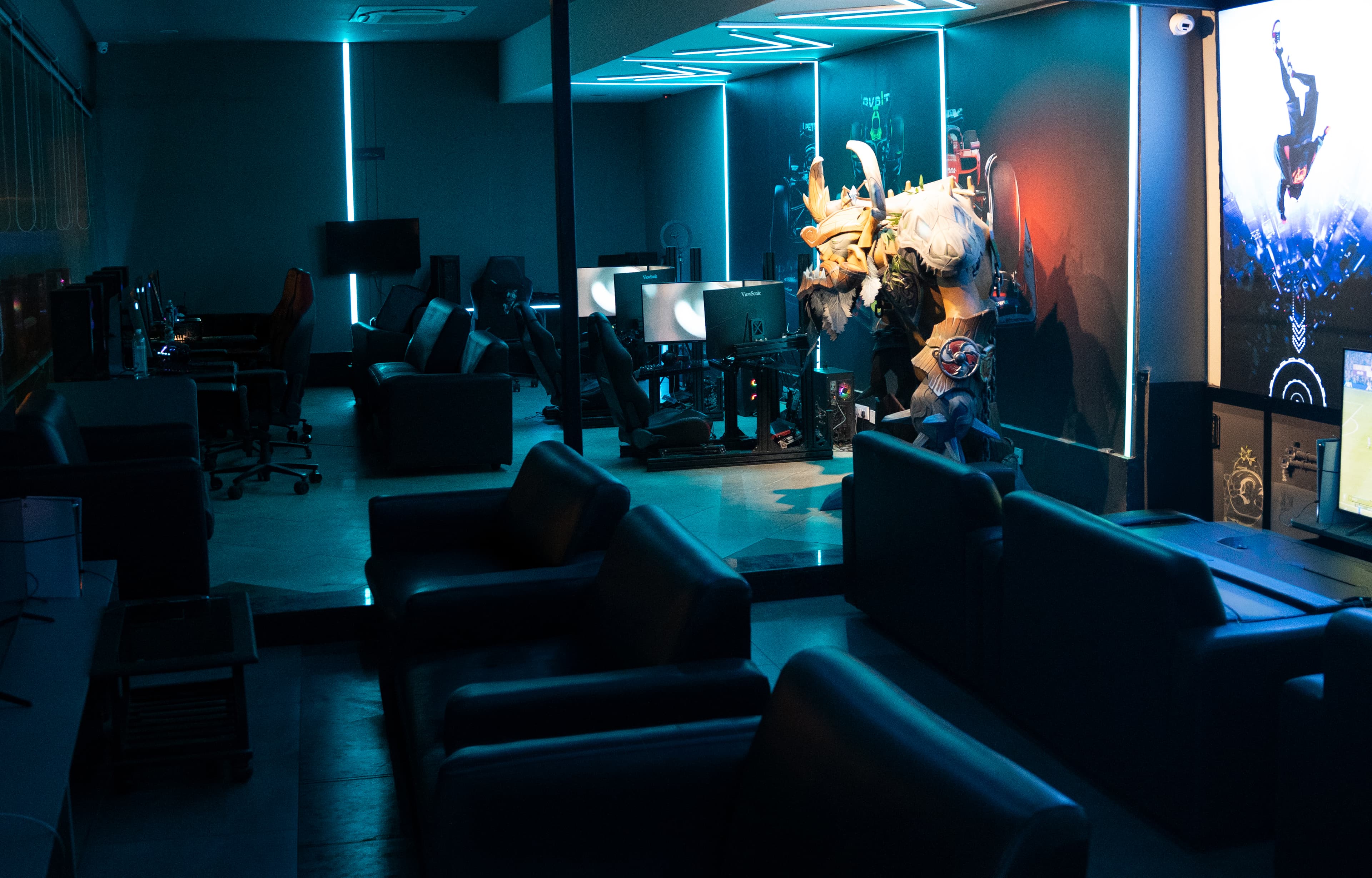 Cyan-lit lounge area at the Gamers Guild Banjara Hills flagship