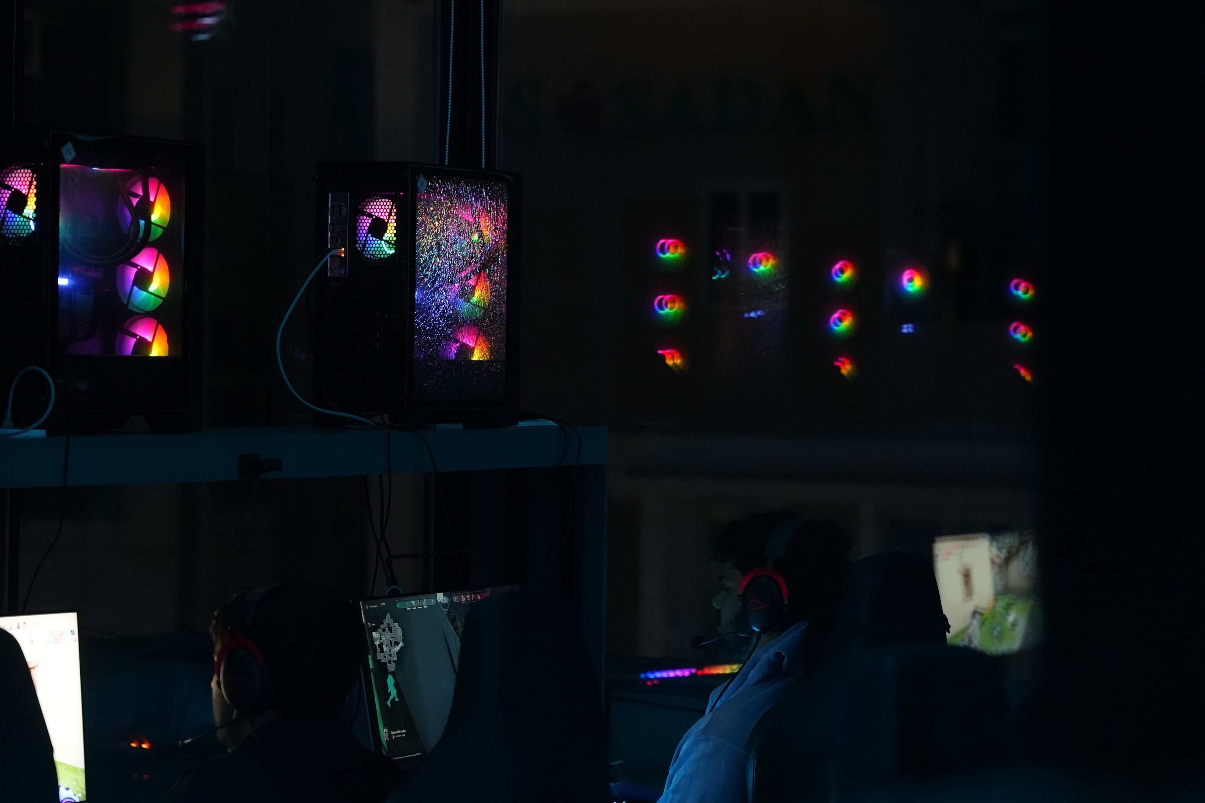 RGB tower PCs glowing on the floor at Gamers Guild